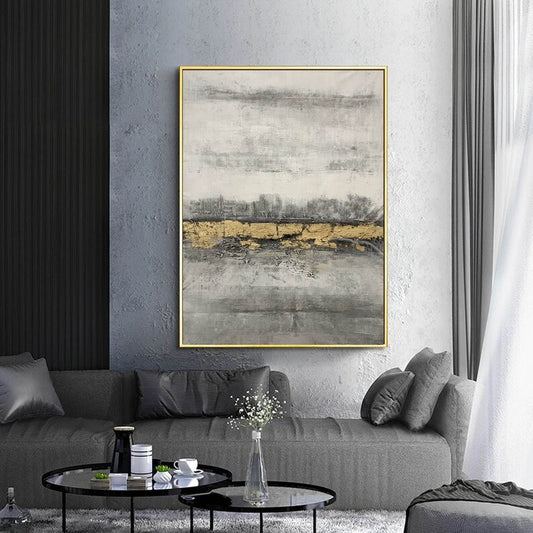 Abstract art piece on a wall above a gray sofa in a living room.