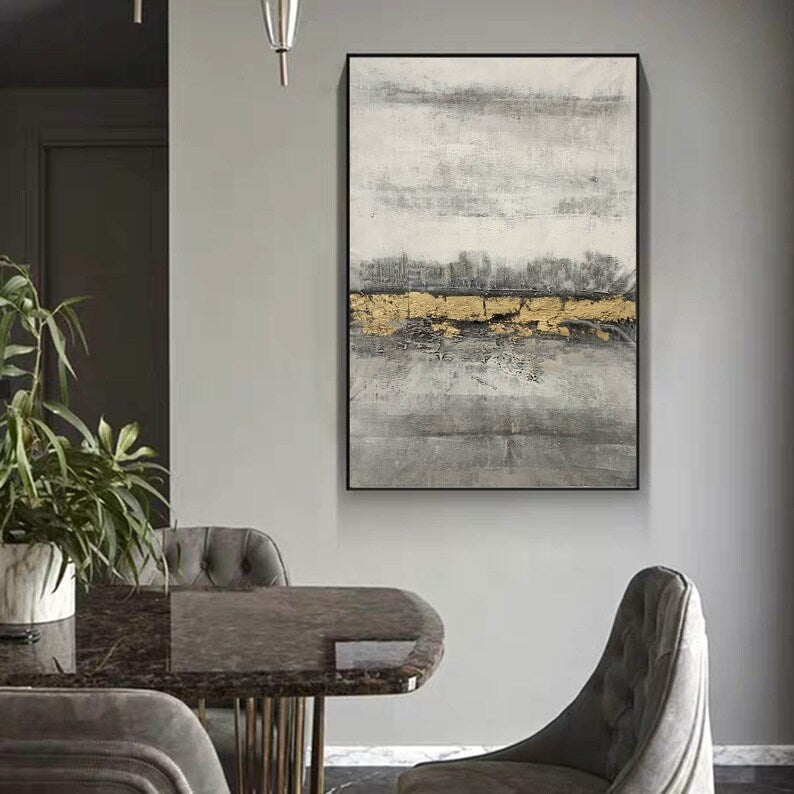 Dining room with a marble table and chairs, abstract art on the wall.