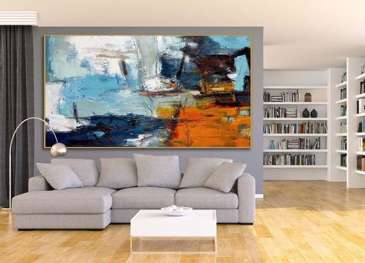 Living room with a gray sofa, coffee table, and abstract painting on the wall.