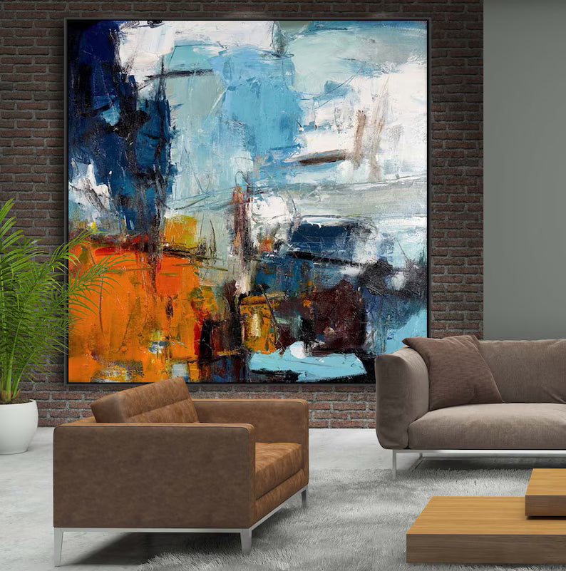 Abstract painting in a modern living room with brown furniture and a plant.