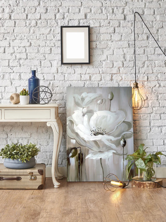 Living room with a white brick wall, floral artwork, and decorative items.