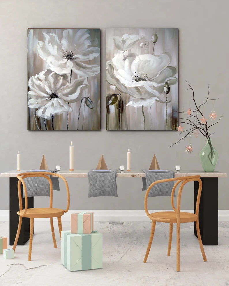 Dining room with floral artwork on the wall and a table set for four.