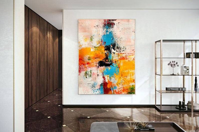 Modern interior with a colorful abstract painting on a white wall.