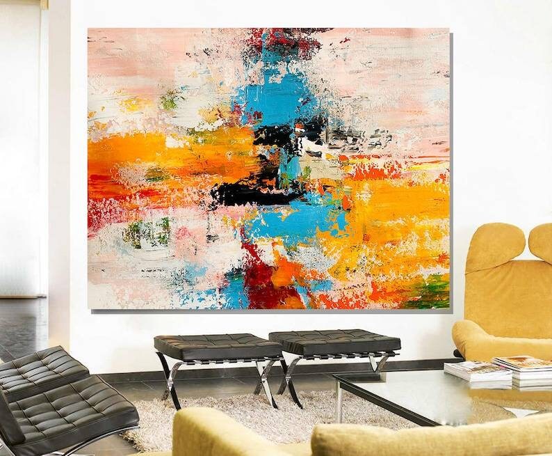 Modern living room with a colorful abstract painting on the wall.