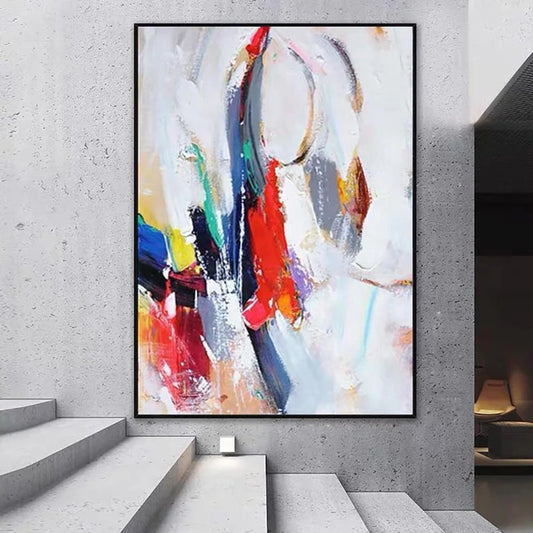 Abstract colorful painting on a gray wall in a modern interior setting.