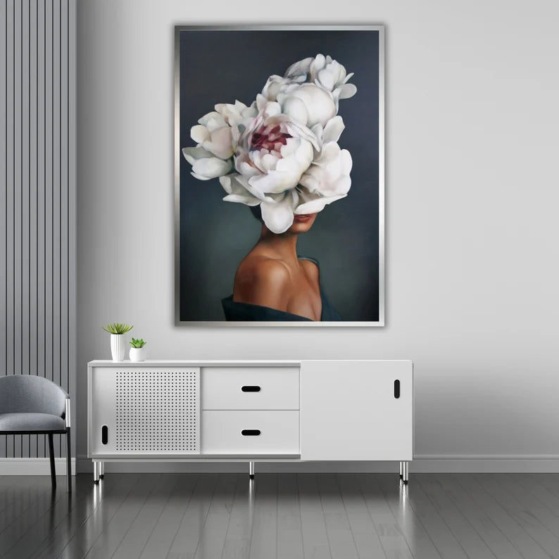 Framed artwork of a woman with white flowers on her head in a modern interior setting.