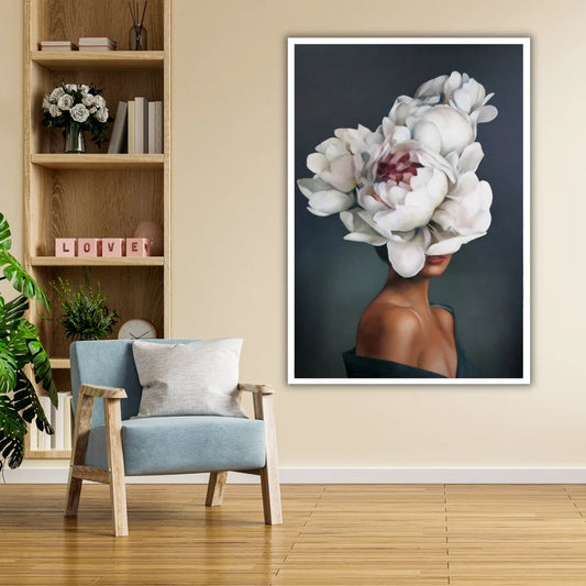 Framed artwork of a woman with floral headpiece in a room with a bookshelf and chair.