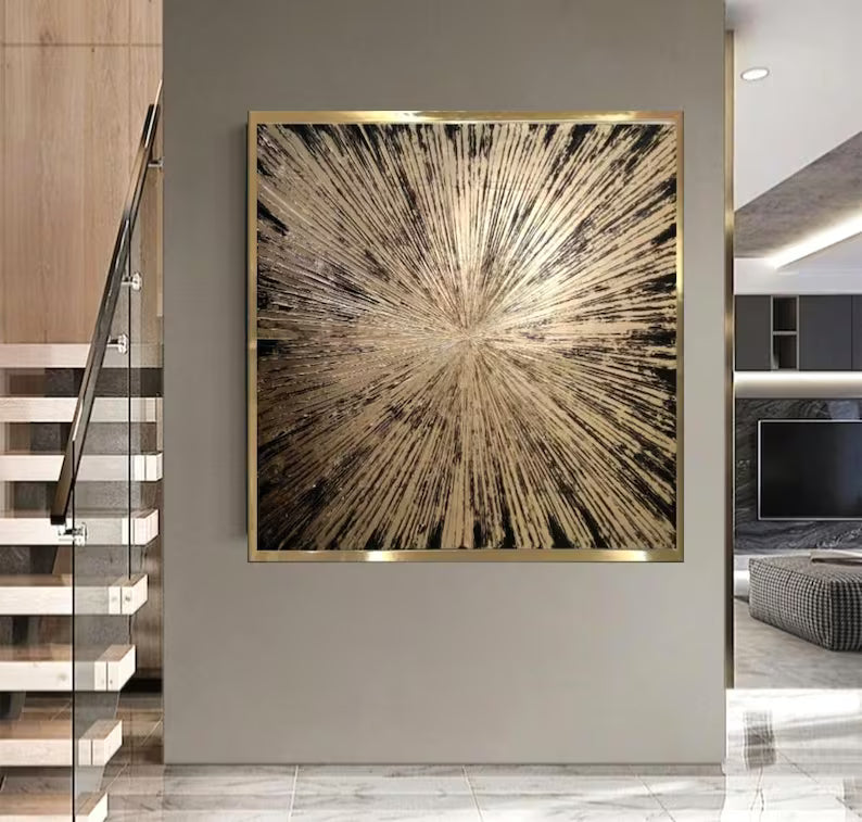 Abstract art piece with a gold frame on a wall in a modern interior setting.