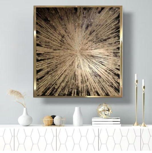 Abstract art piece with a gold frame on a wall above a white console table with decorative items.