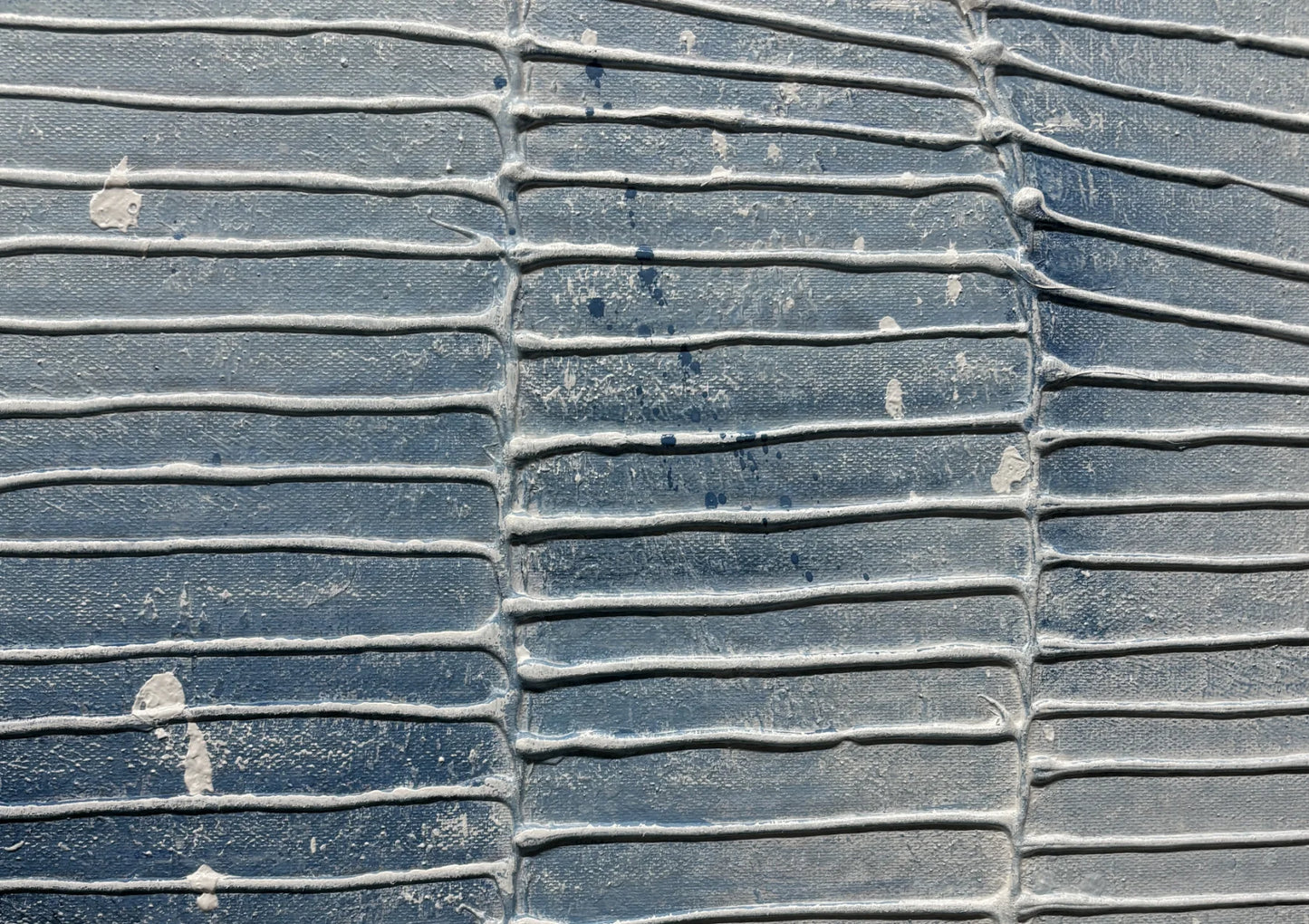 Close-up of a textured blue surface with white patches