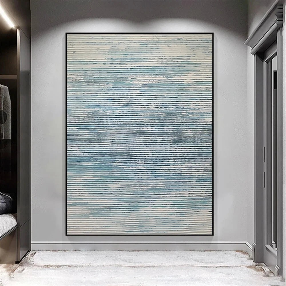 Abstract art piece with blue and gray tones on a wall in a modern interior setting.