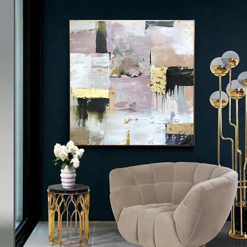 Modern interior with abstract painting, beige armchair, and decorative lamp.