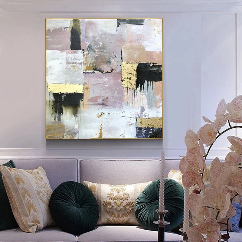 Abstract painting on a wall above a sofa with decorative pillows and a lamp.