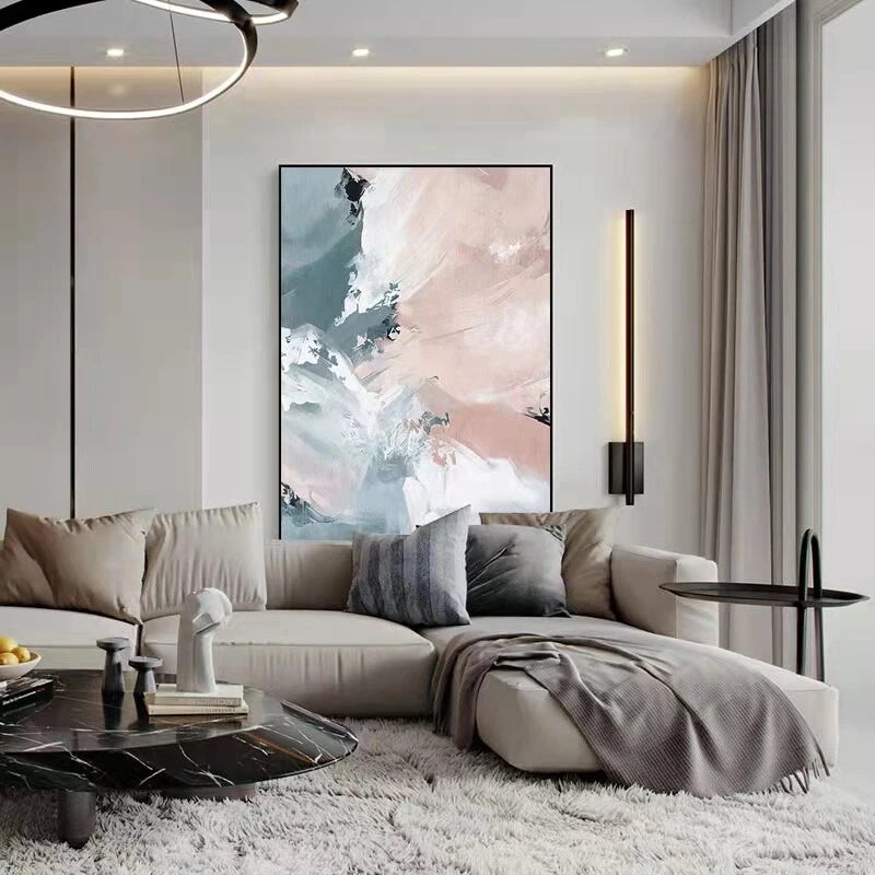 Modern living room with a sofa, coffee table, and abstract artwork on the wall.