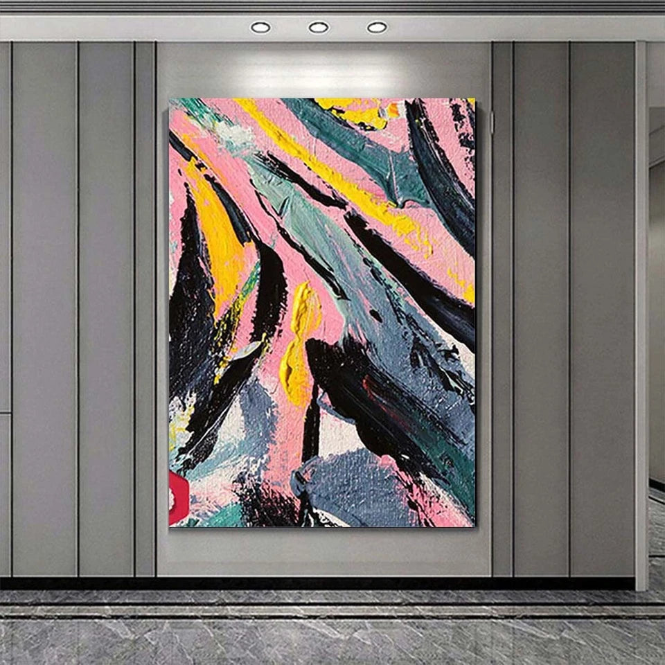 Abstract painting with pink, yellow, and black colors on a gray wall.