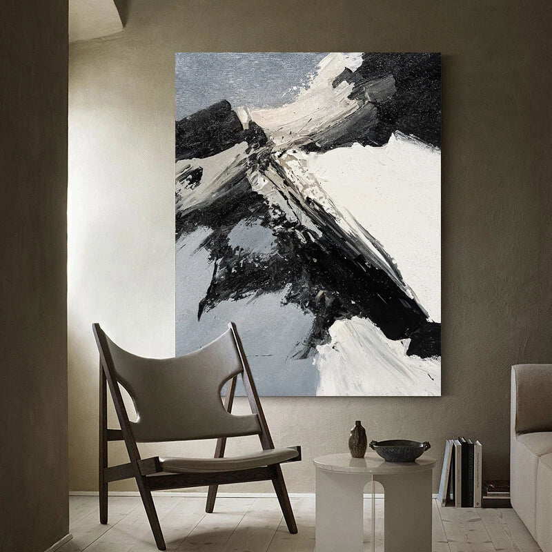 Abstract painting in a modern living room setting with a chair and side table.