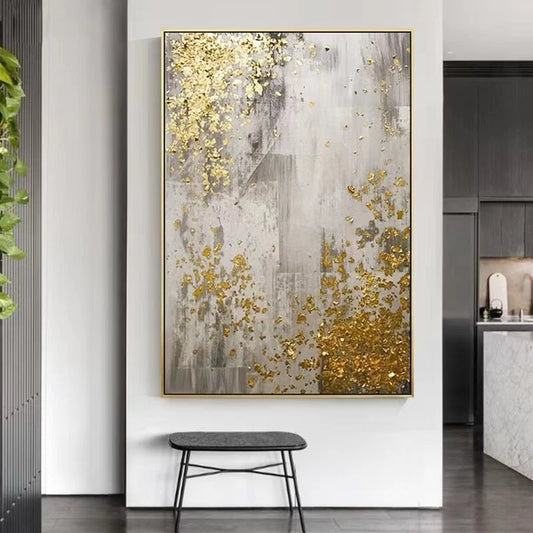 Abstract art piece with gold and gray colors in a modern interior setting.
