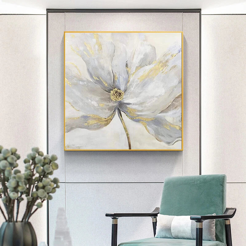 Decorative floral painting on a wall with a chair and plant in the foreground.
