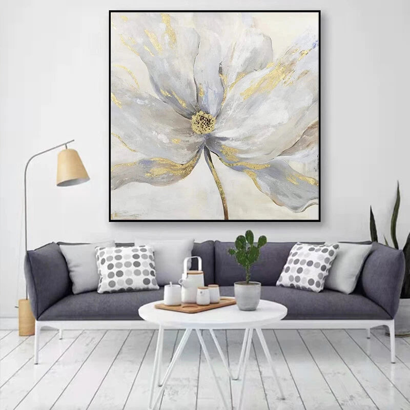 Living room with a large abstract floral painting on the wall, gray sofa, and white coffee table.