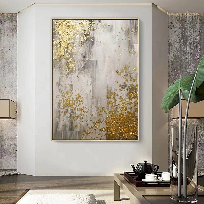 Abstract art piece with gold accents on a wall in a modern interior setting.