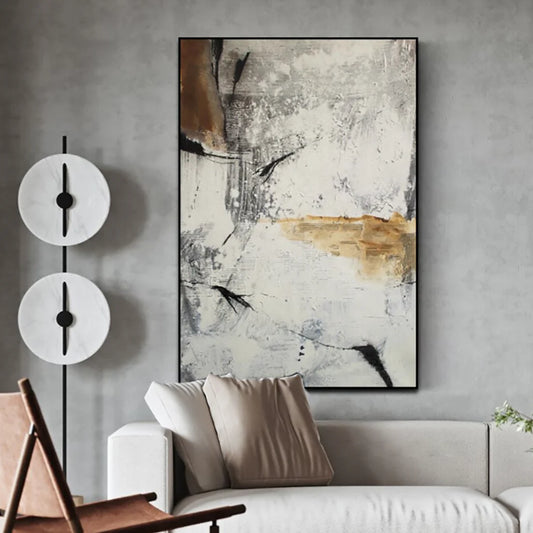Abstract painting on a wall above a sofa in a living room setting