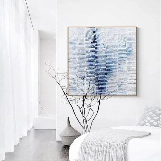 Abstract blue and white painting on a wall with minimal decor
