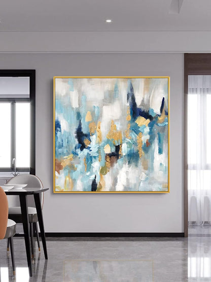 Abstract painting with blue, gold, and white colors in a modern interior setting.