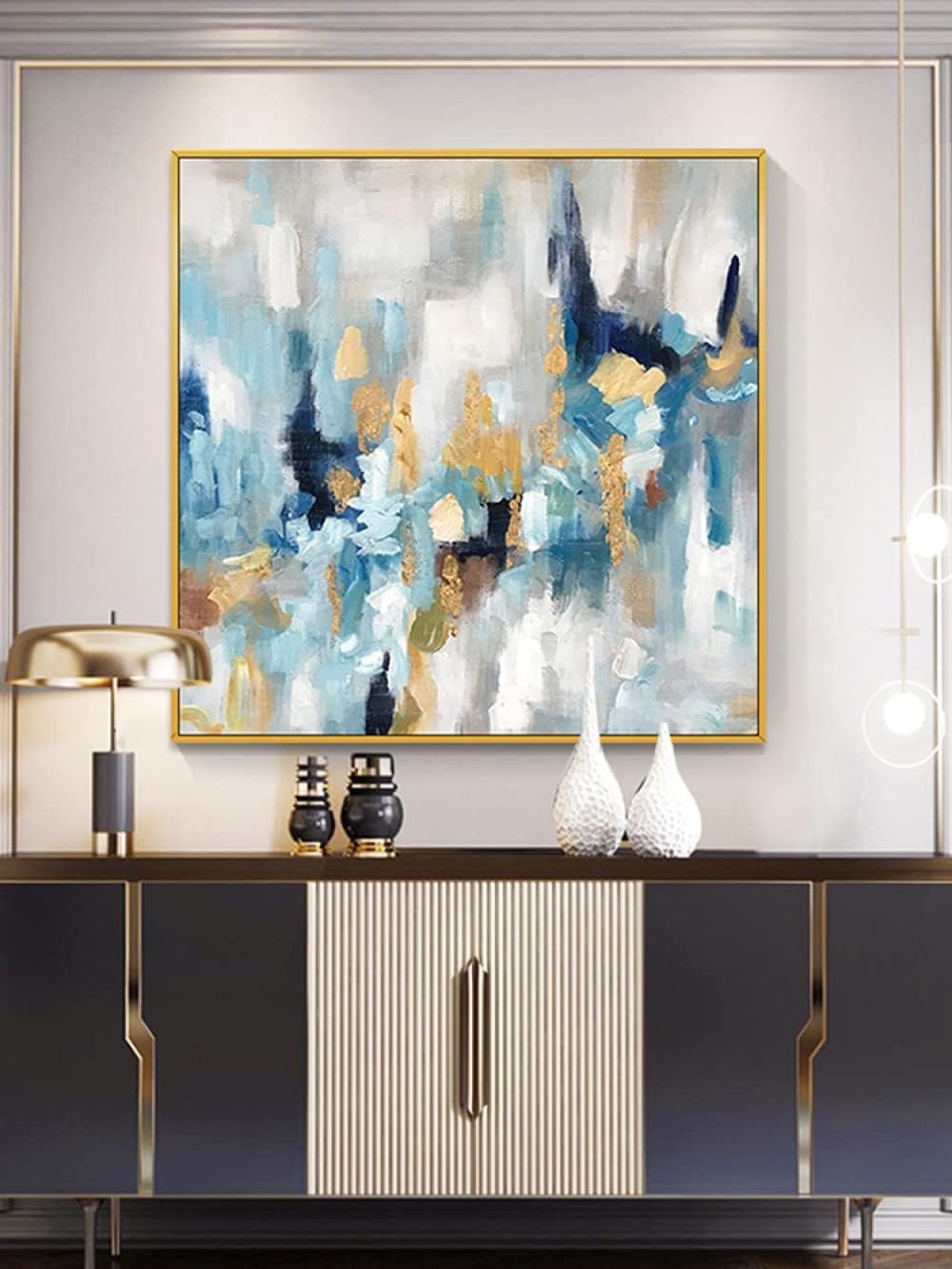 Abstract painting on a wall above a console table with decorative items.