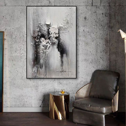 Abstract painting on a textured wall above a modern chair and side table.