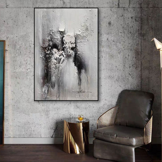 Abstract painting on a textured wall above a modern chair and side table.
