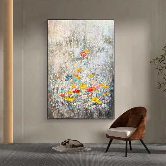 Abstract floral painting on a wall above a brown chair and small table.