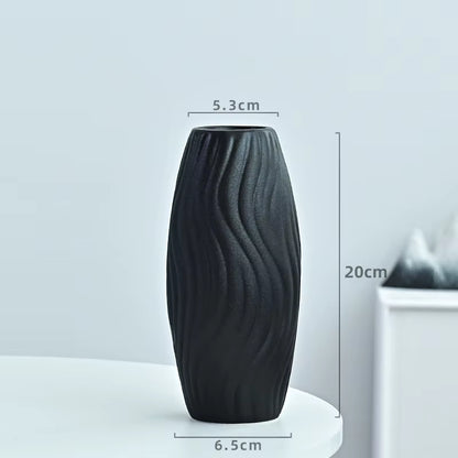 Black textured vase with measurements on a light gray background