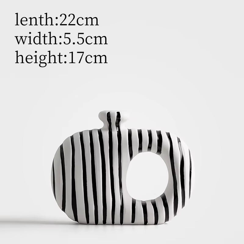 Black and white striped pouch with measurements on a light gray background