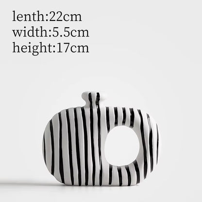 Black and white striped pouch with measurements on a light gray background