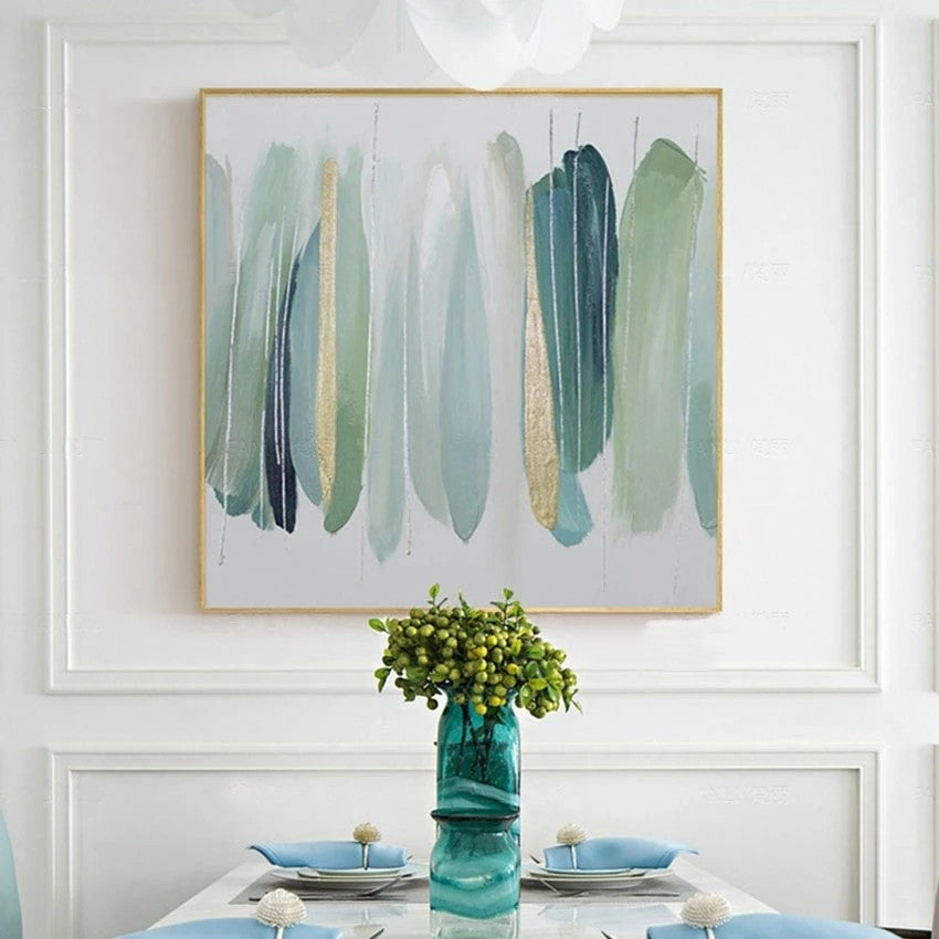 Abstract art piece on a wall above a dining table with a vase and flowers.