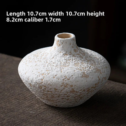 White textured vase on a dark surface with dimensions displayed