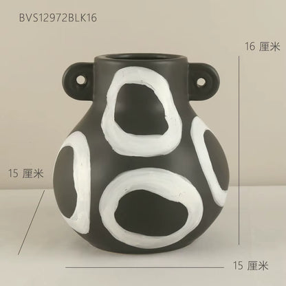 Black and white ceramic vase with measurements on a beige background
