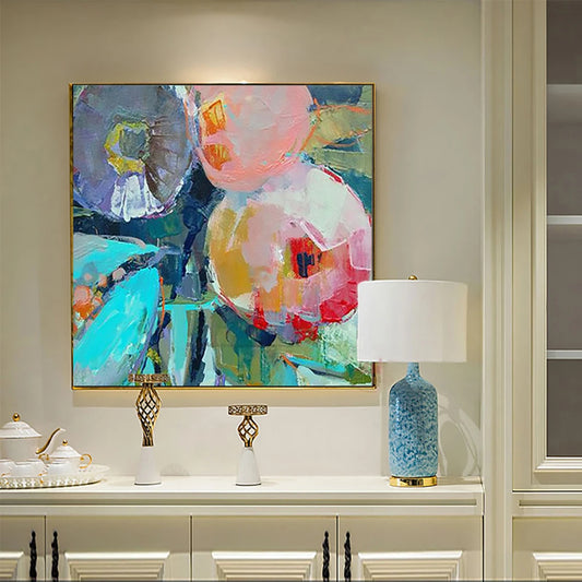 Colorful abstract painting on a wall above a cabinet with decorative items.