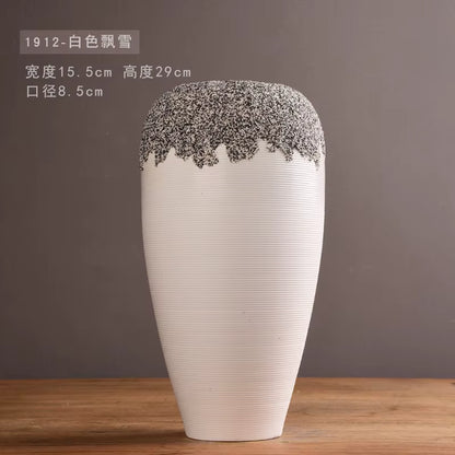 White vase with decorative top on a wooden surface and brown background