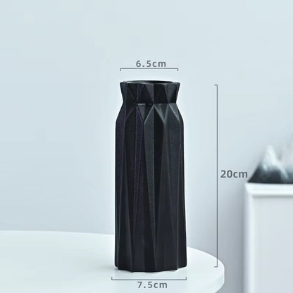 Black geometric vase with measurements on a light gray background