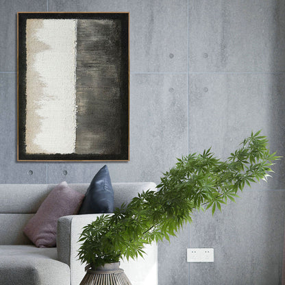 Abstract painting on a gray wall above a sofa with decorative pillows and a plant.