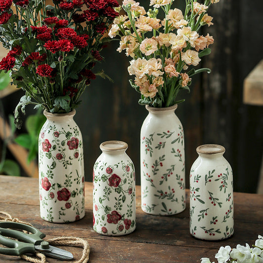 Set of decorative vases with floral patterns on a wooden surface