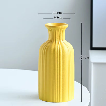 Yellow vase with measurements on a white surface