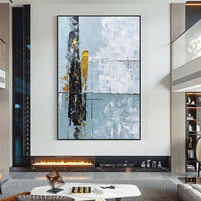 Abstract art piece on a wall above a fireplace in a modern living room.