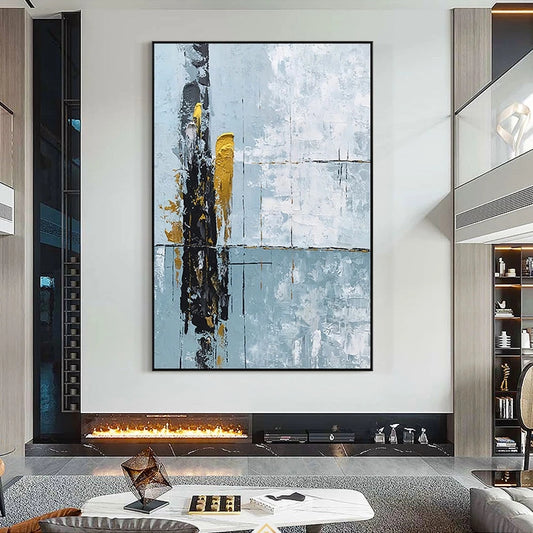 Abstract art piece on a wall above a fireplace in a modern living room.