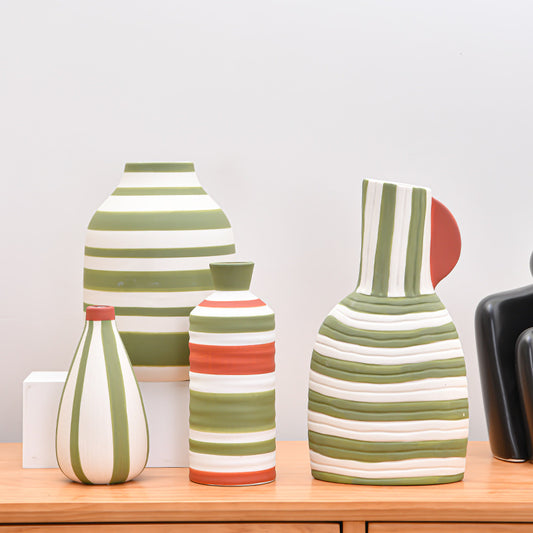 Set of striped ceramic vases on a wooden surface with a neutral background