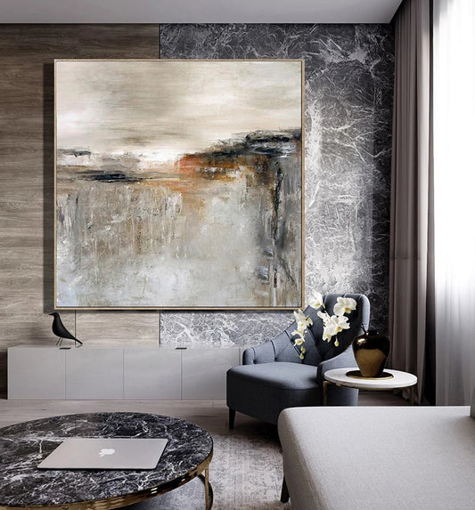 Modern living room with abstract painting, gray sofa, and marble coffee table.
