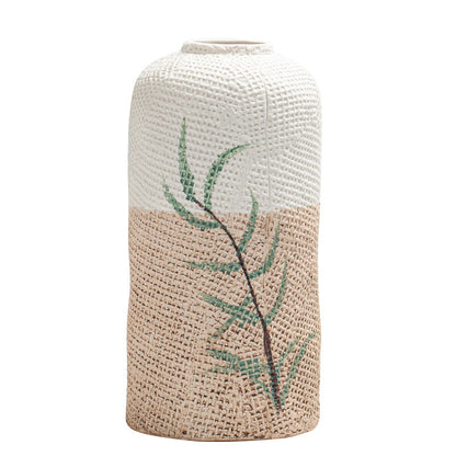 Textured vase with leaf design on a white background