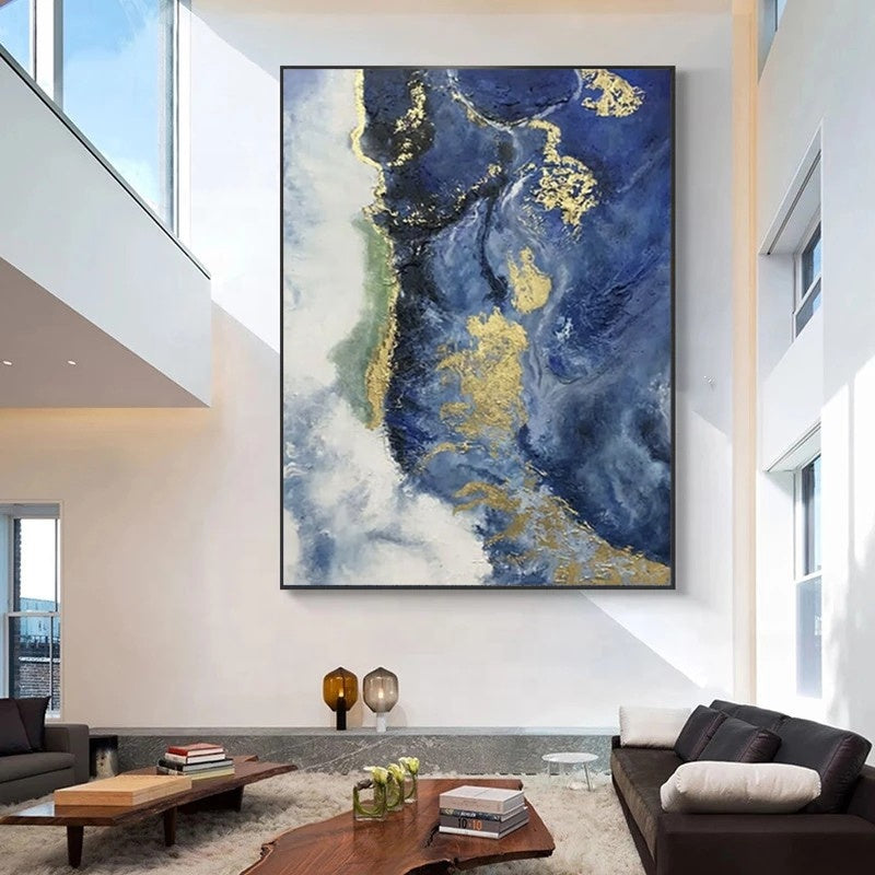 Modern living room with abstract blue and gold painting on the wall
