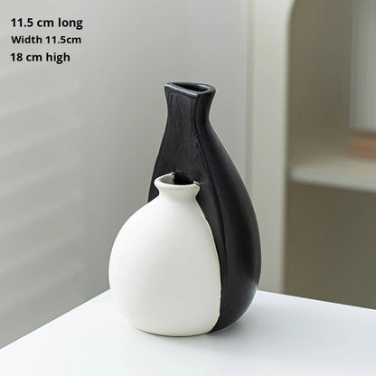 Black and white ceramic vase on a light surface with measurements displayed.